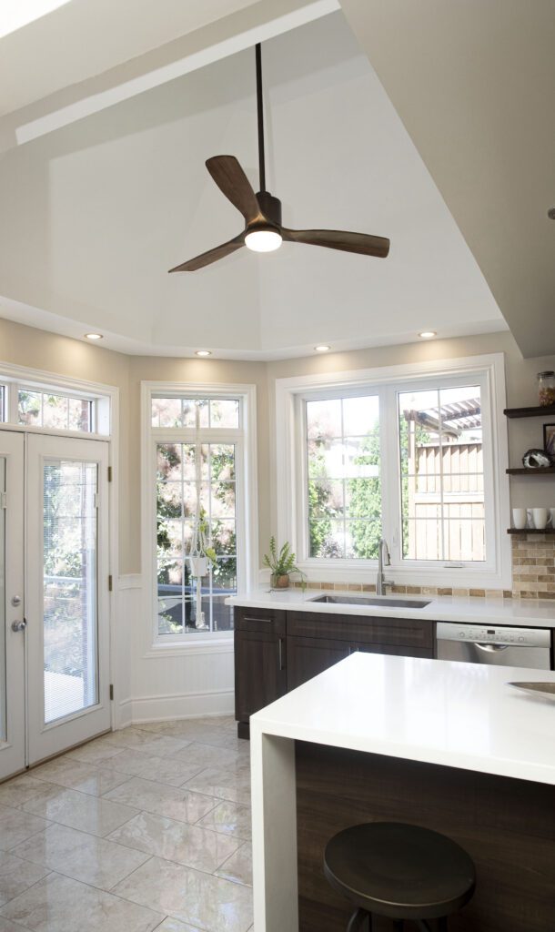 grand family kitchen with vaulted ceiling and fan.