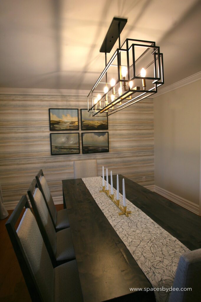 modern farmhouse country-inspired dining room with a soft pastel color palette, wall art and plants and wallpaper.