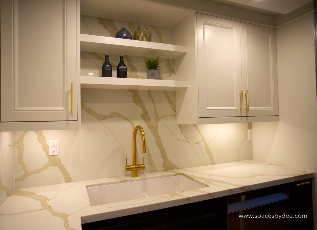 small contemporary black and white condo kitchen with gold accents.