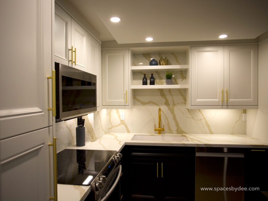 small contemporary black and white condo kitchen with gold accents.