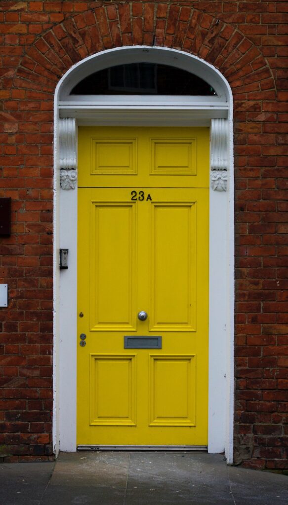 yellow funky exterior large front door.