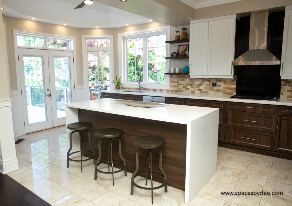 grand large family-style kitchen with open shelves, decor and 2-toned cabinetry white and brown with vaulted ceiling and fan.
