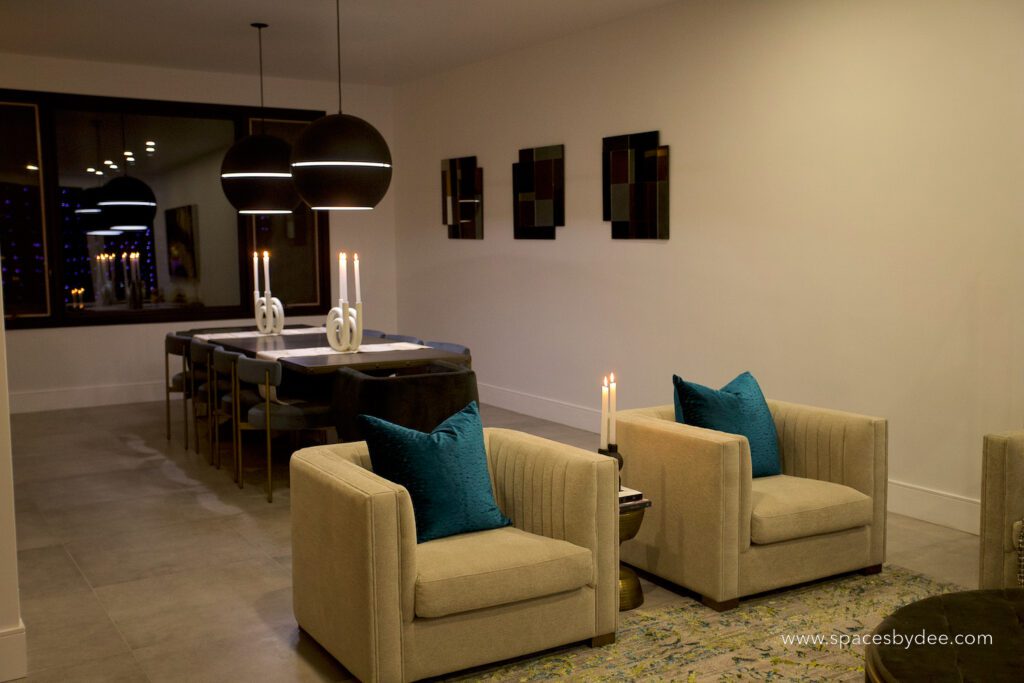 super contemporary modern living and dining room with dramatic light fixtures and pops of colour.