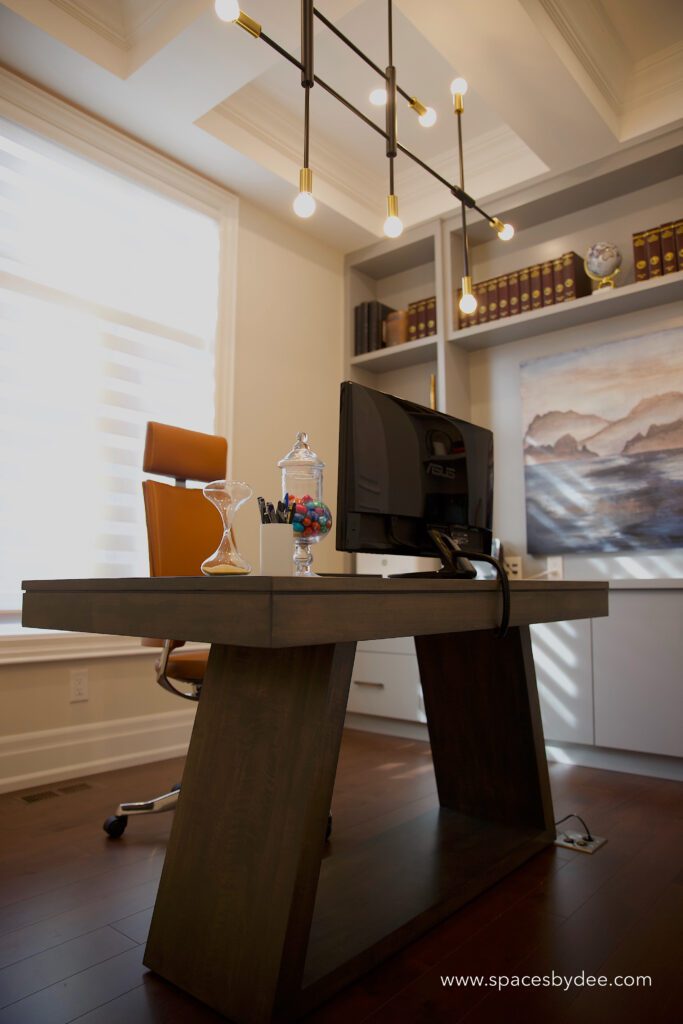 bright and light home office with funky, cool, unique desk and grey decor accents.