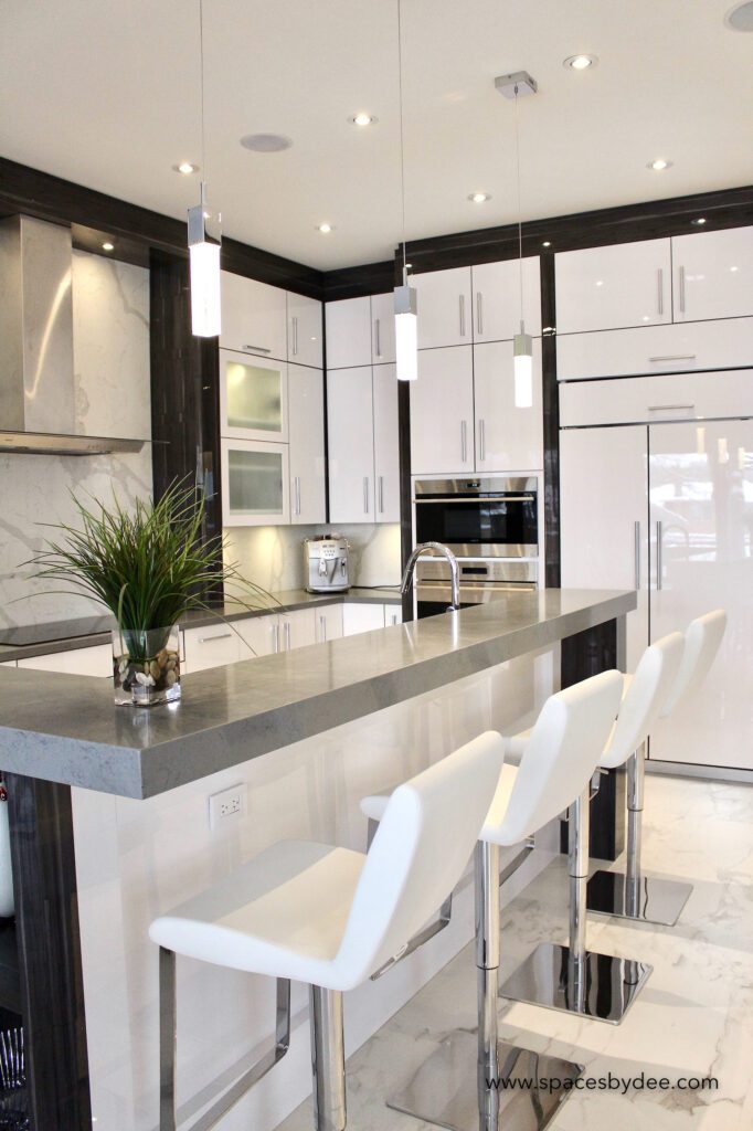 super modern large white, black and grey minimalistic kitchen with stone backsplash.