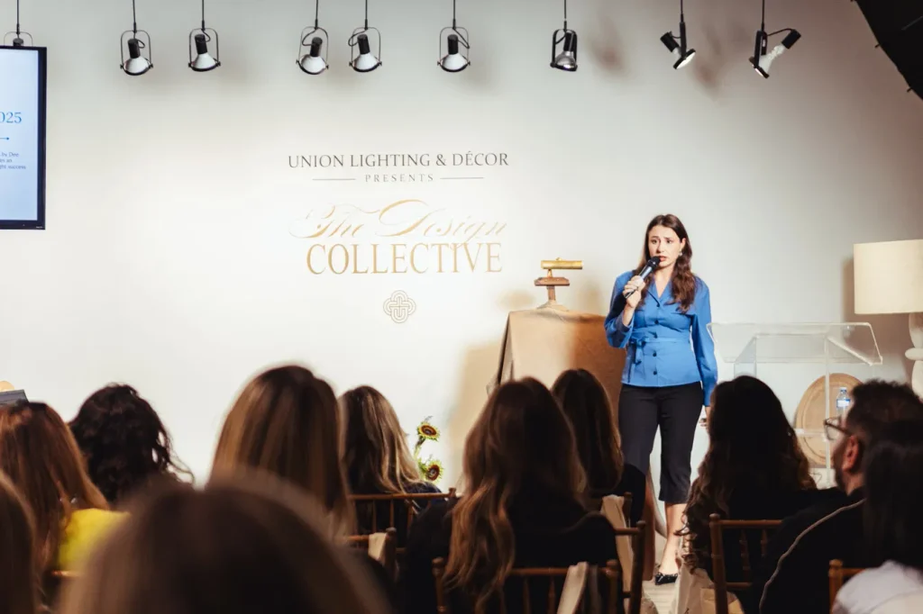 Dee of Spaces by Dee speaking on stage to an audience of interior designers